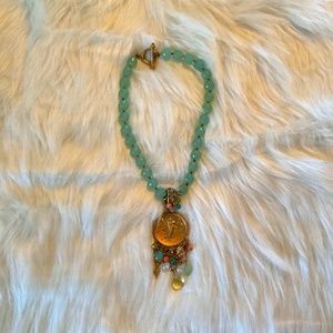 Green and gold medallion necklace with pastel accent beads and jewels